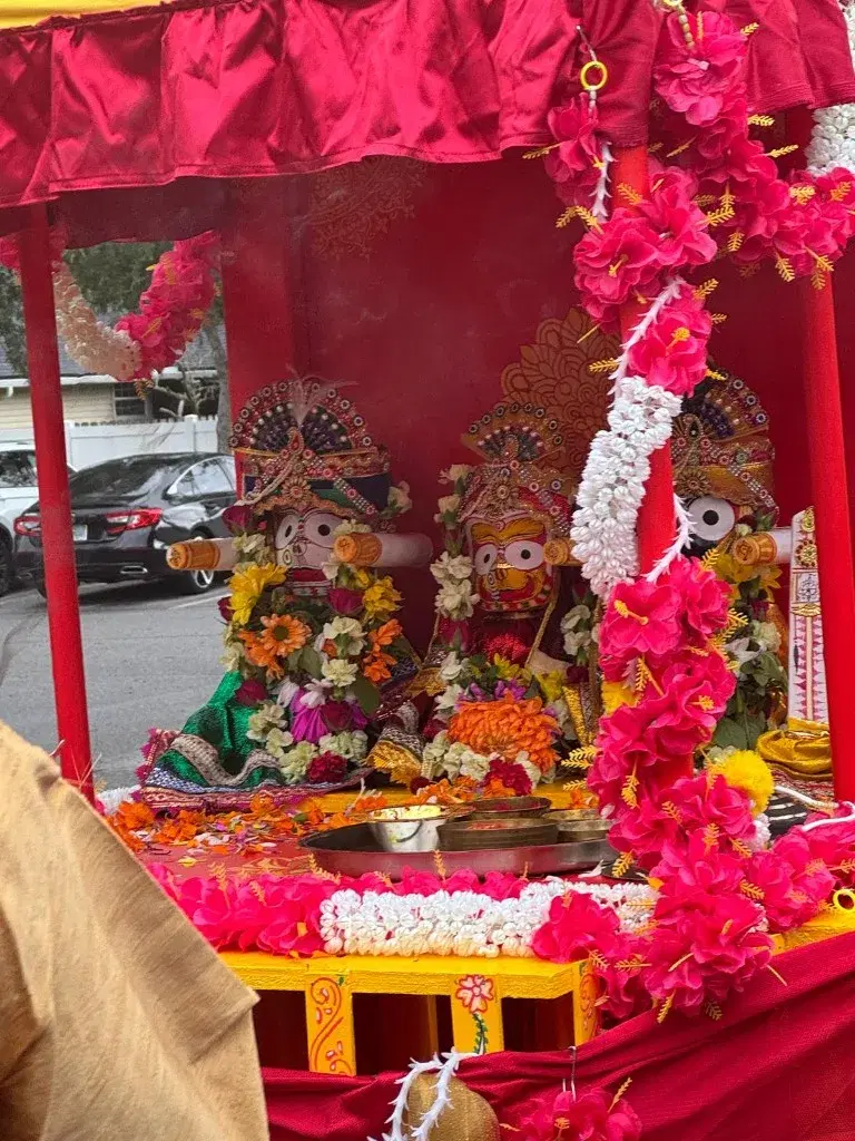 Lord Jagannath, Balabhadra, and Subhadra on the chariot with flower garlands